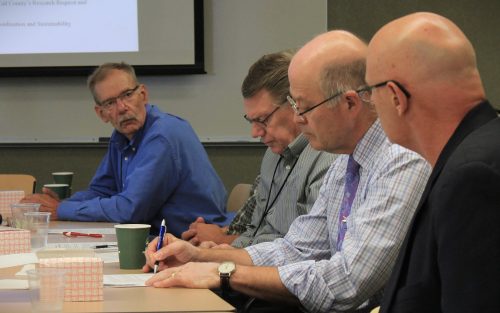 Four men in a meeting