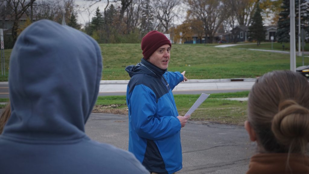 Man talking and pointing to road