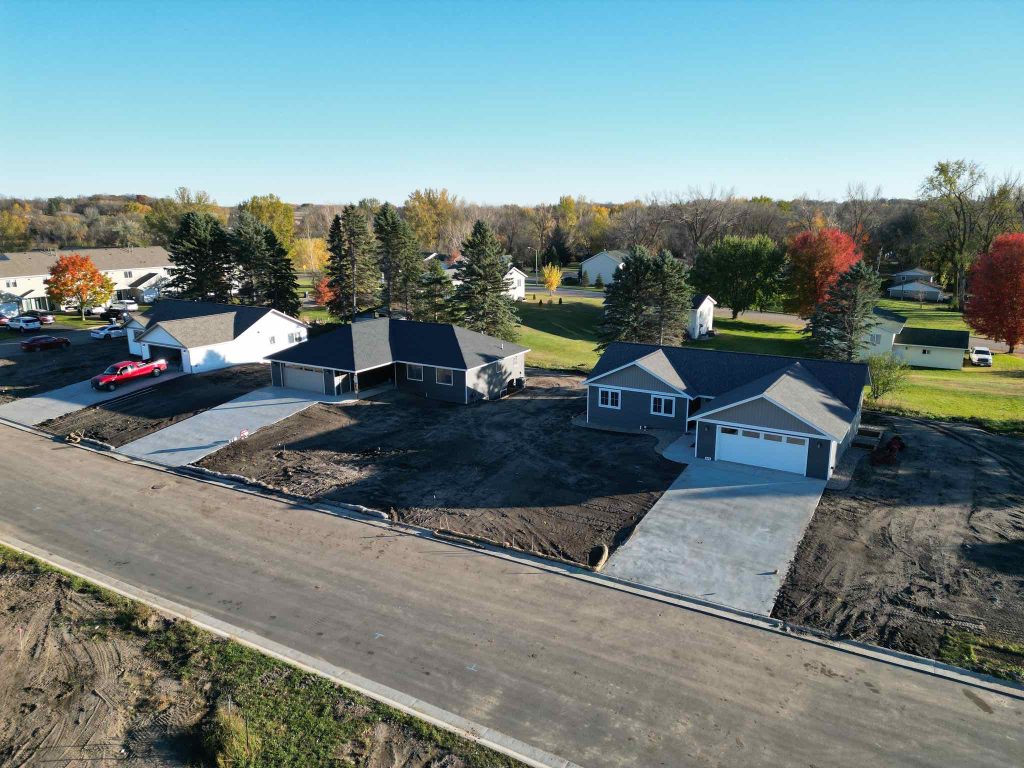 Aerial view of three houses at the site of the completed Pinewood Estates in Pelican Rapids