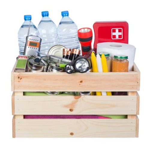 Objects useful in emergency situations such as natural disasters in wooden box isolated on white background
